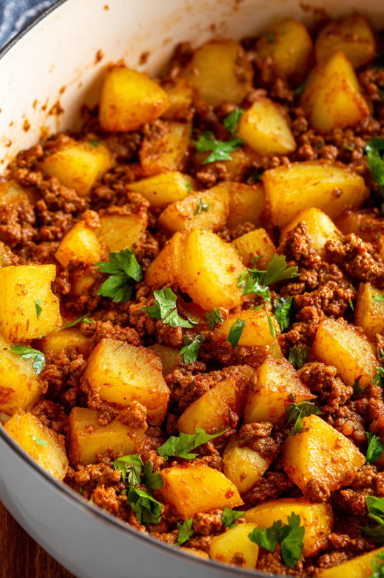 Ein Topf mit Papas con Chorizo, das bedeutet "Potatoes with sausage", enthält eine Mischung aus Papas (Potatoes) und Chorizo (sausage).